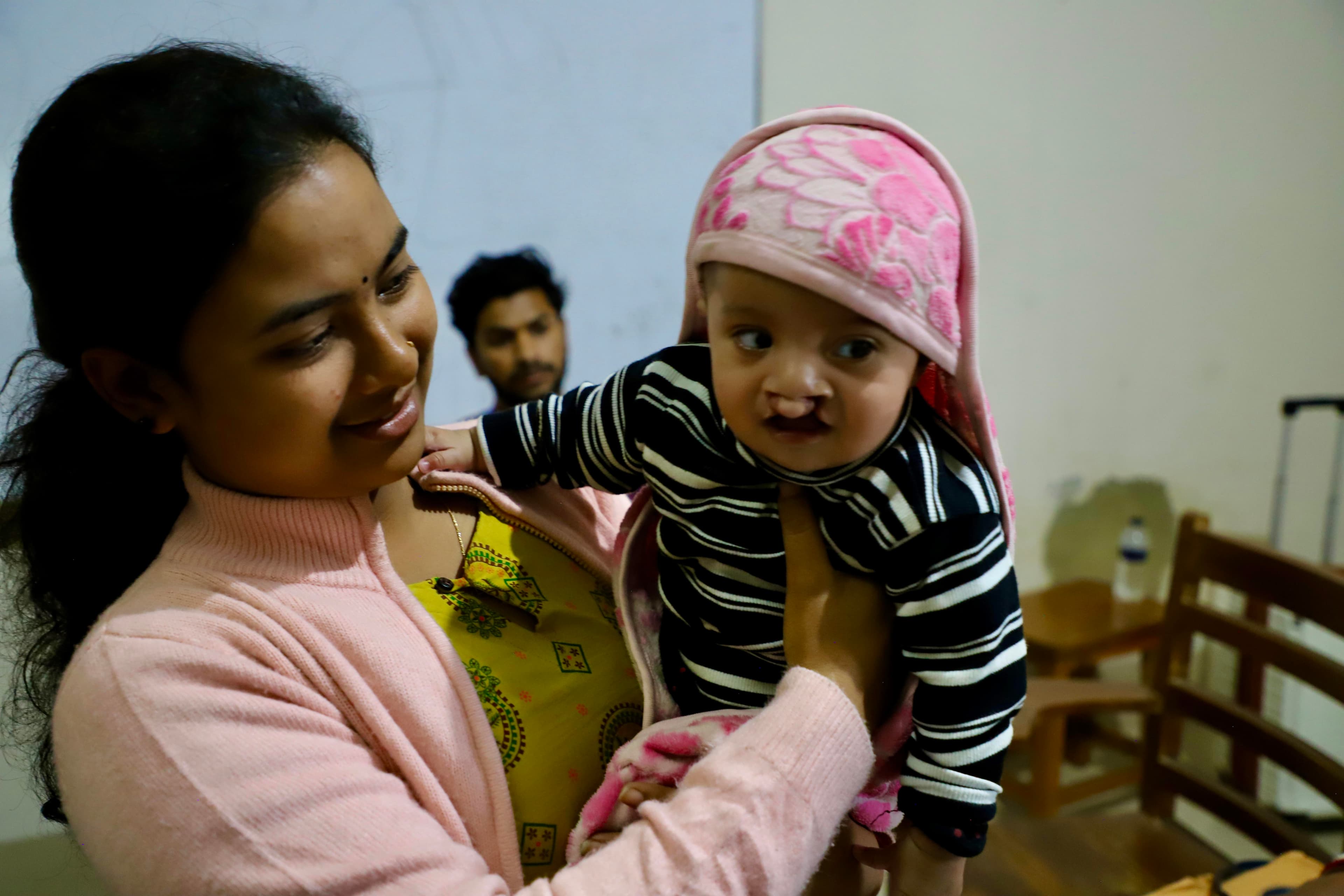 Mother holding her child before cleft surgery in Bangladesh